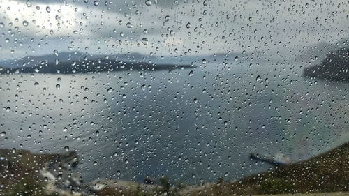 Full frame shot of wet glass window during rainy season