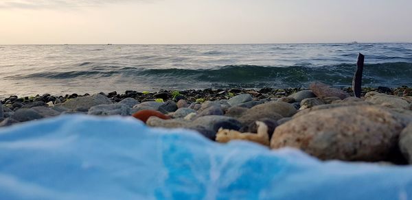 Rocks on beach against sky