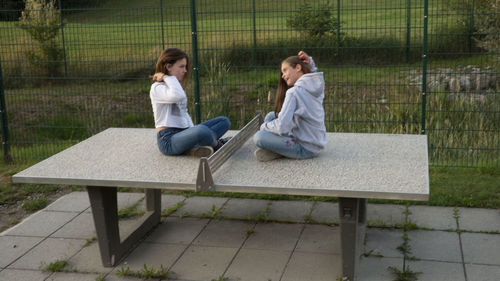 Woman sitting on bench in park