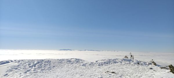 Scenic view of snow covered landscape against sky