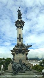 Low angle view of statue against cloudy sky