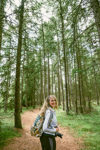 Woman standing in forest