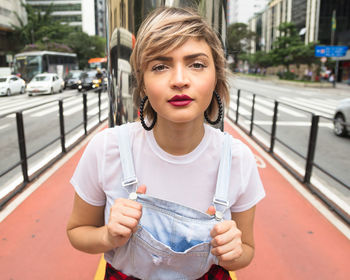 Portrait of teenage girl standing in city