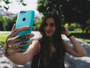 Young woman taking selfie on smart phone