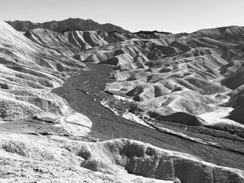 Scenic view of rocky mountains against clear sky in death vallet