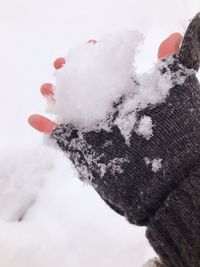 Close-up of hand on snow