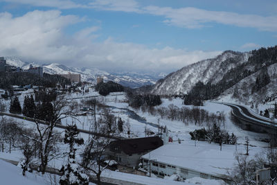 Scenic view of snow covered mountains against sky