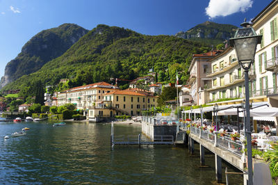 High angle view of lake como by town against sky