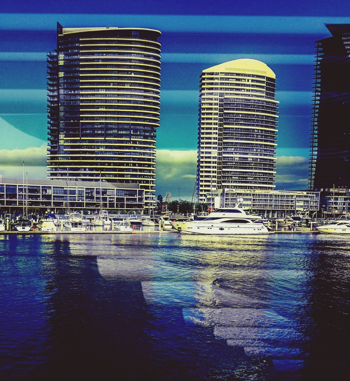 water, architecture, building exterior, built structure, waterfront, reflection, blue, city, sky, sea, illuminated, modern, transportation, building, nautical vessel, office building, river, skyscraper, no people, outdoors