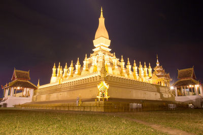 Illuminated temple building against sky at night