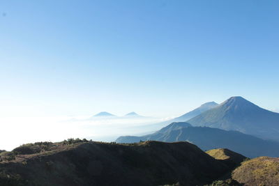 Scenic view of mountains against clear blue sky