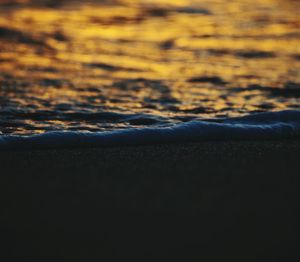 Close-up of sea against sky at sunset