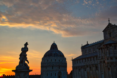 Statue of historic building against sky during sunset