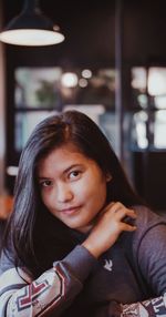 Portrait of a young woman sitting at restaurant