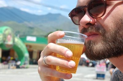 Close-up of man drinking beer