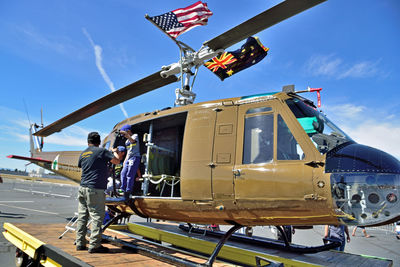 Low angle view of people by helicopter