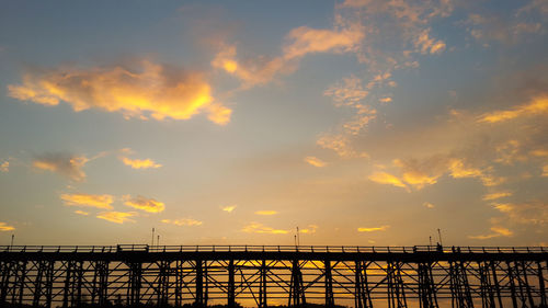 Silhouette bridge against sky during sunset