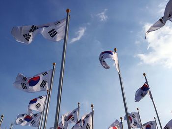 Low angle view of south korean flags against sky