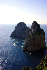 Scenic view of sea and rock formation against sky