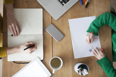 High angle view of man and woman reading book