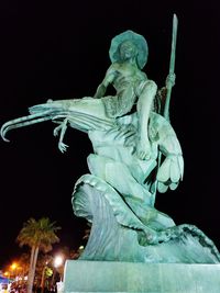 Close-up of statue against sky at night