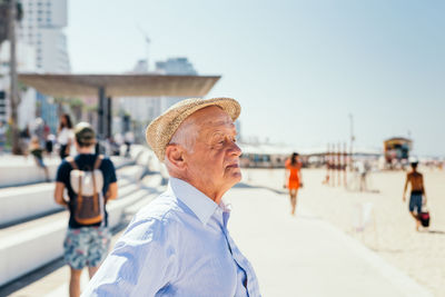 People at beach against sky