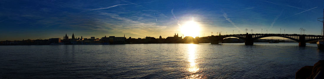 Bridge over river against sky during sunset