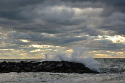 Scenic view of sea against storm clouds