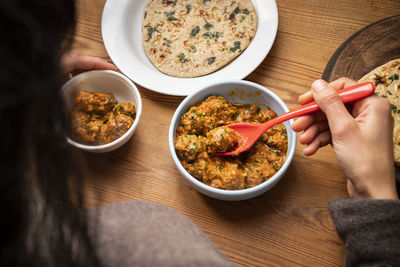 High angle view of person preparing food on table