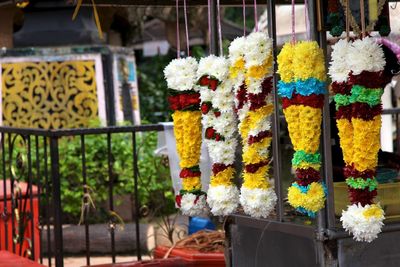 Close-up of multi colored flower pots hanging at market stall