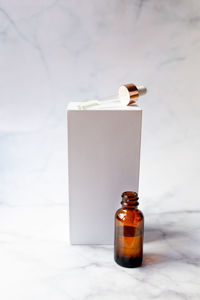 Retinol oil serum oil bottle on isolated marble background