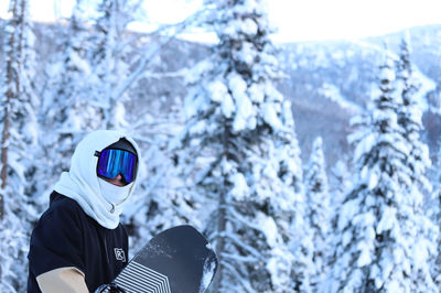 Rear view of man standing on snow
