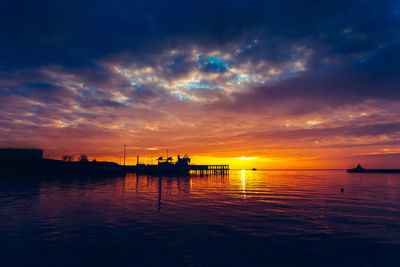 Scenic view of sea against orange sky