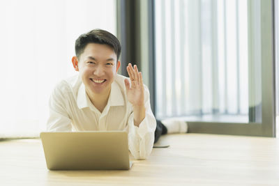 Portrait of smiling man sitting on table