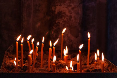 Close-up of burning candles in temple