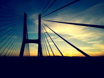 Low angle view of suspension bridge against sky