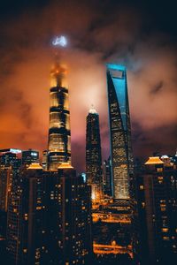 Illuminated buildings against sky at night