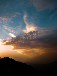 Scenic view of silhouette mountains against sky during sunset