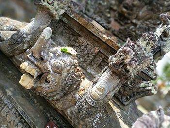 Close-up of buddha statue against building