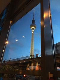 Low angle view of illuminated tower against sky at night