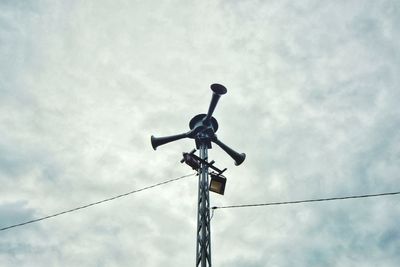 Low angle view of telephone pole against sky