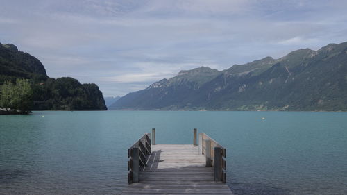 Pier on lake against mountains