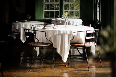 Empty chairs with table at restaurant