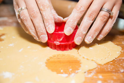 Cropped image of person making cookies