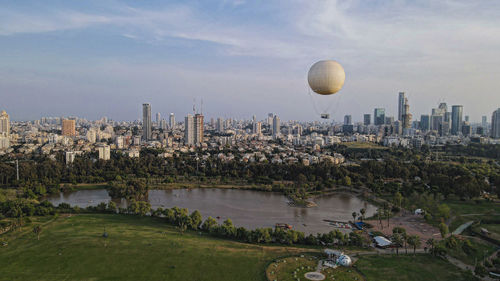 Aerial view of buildings against cloudy sky