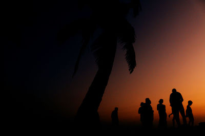 Silhouette people against sky during sunset