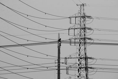 Low angle view of electricity pylon against sky