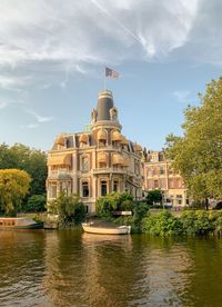 Building by lake against sky