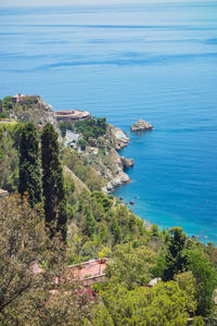 High angle view of sea and trees against sky