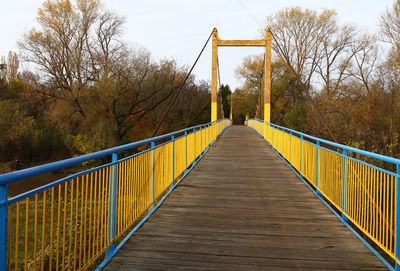 Bridge over trees against sky